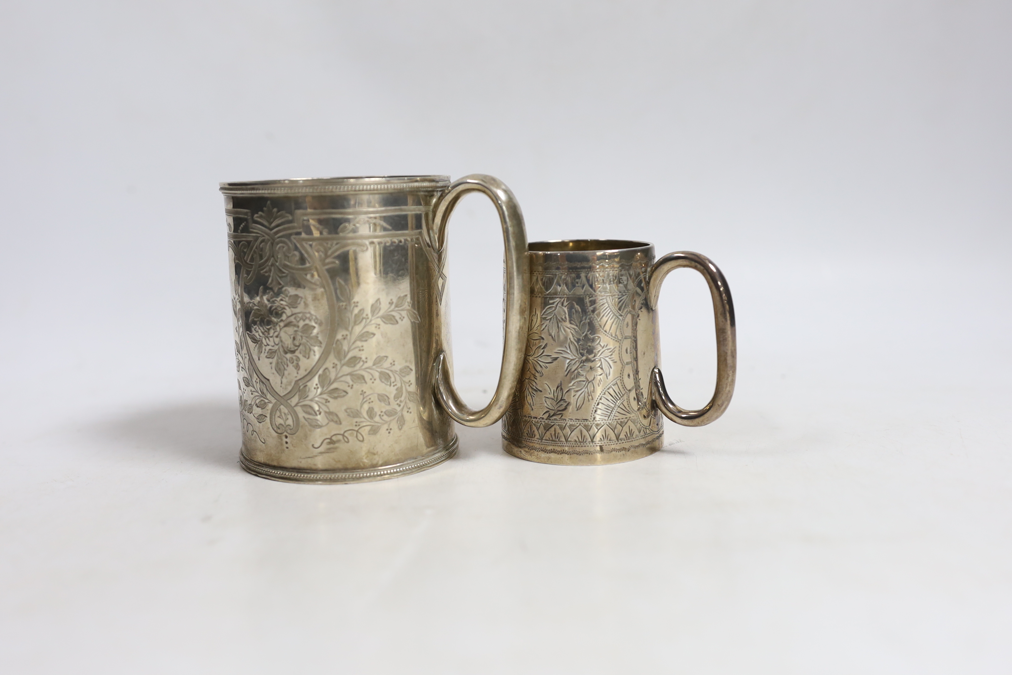 A Victorian engraved silver christening mug, Roberts & Belk, Sheffield, 1873, 87mm, together with another smaller engraved silver mug, Birmingham, 1893.